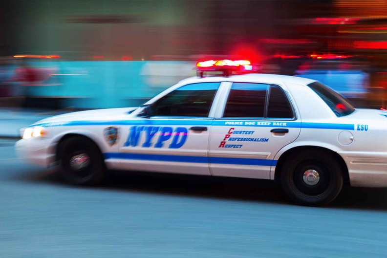NYPD cop car with siren on