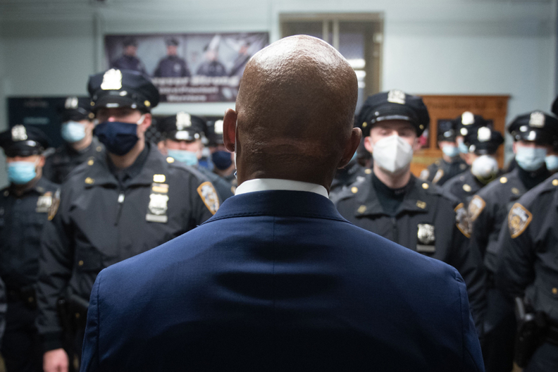 The back of Eric Adams facing NYPD officers
