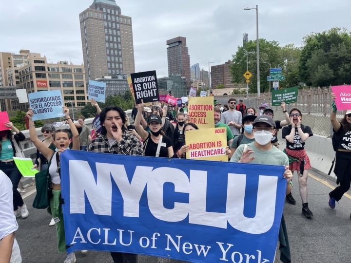 Staff, student activists, and volunteers holding a NYCLU banner and pro-choice signs at a rally defending abortion rights after Roe v Wade was overturned